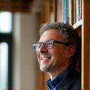 Our lead instructor sitting in a library